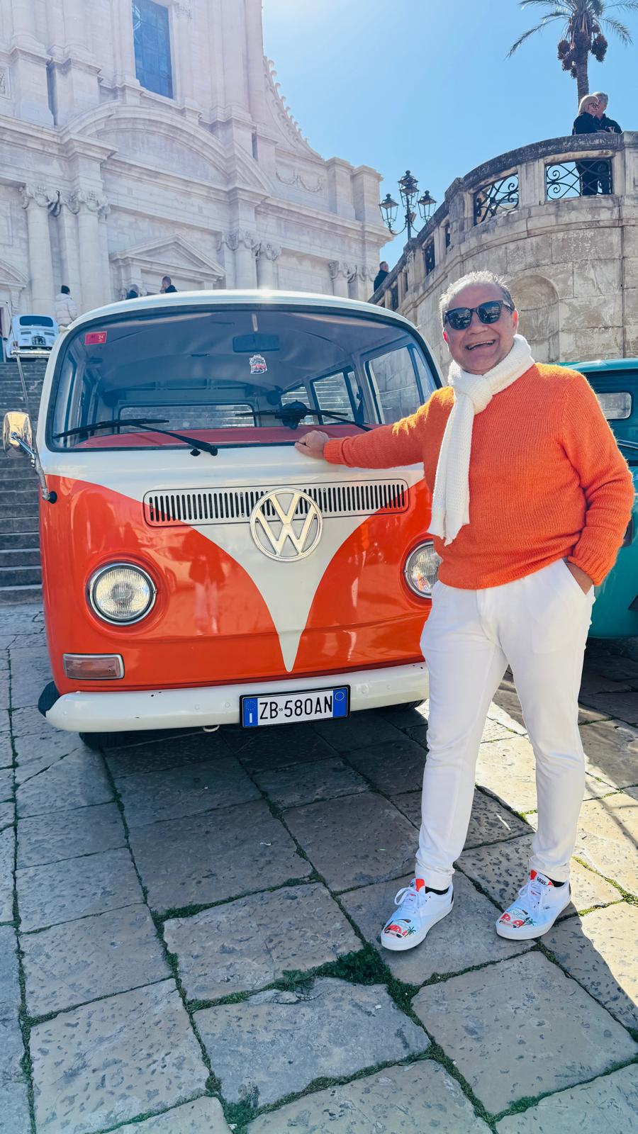Mario, licensed Sicilian driver-guide, with his vintage VW van in front of a baroque cathedral